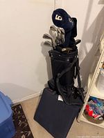 Full view of golf bag with clubs and seat on floor