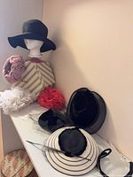 Shelf view showing multiple hats and fascinators