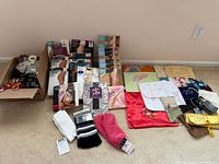 Group view of hosiery packages, socks and pouches laid out on floor