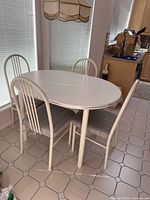Full view of oval table with four matching chairs