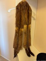 Full view of brown mink stole hanging to show length and tails