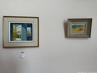 Both framed paintings hung side-by-side on wall for scale reference