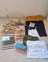 Overall lot: shoe rack, hangers, garment and dust bags