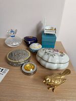 Group view of all trinket boxes, musical box, handbag hanger and angel figurine