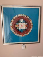 Full view of framed lithograph showing mandala design and frame