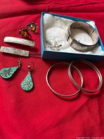 Group shot showing all jewelry pieces on red fabric