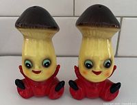 Front view showing both anthropomorphic mushroom shakers