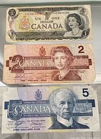 Three Canadian banknotes $1, $2, $5