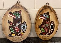 two painted wood plaques front view