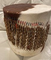 Front view showing cowhide pattern and fringe lacing