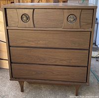 Front view of mid-century dresser showing drawer arrangement and legs