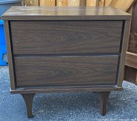 Front view showing entire nightstand, two drawers, tapered legs