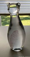 front view of clear glass cat figurine with internal swirl