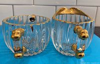 Creamer and sugar bowl front view showing ribbed glass, hobnail bases and gold handles