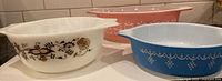 Three Pyrex casseroles showing colors and patterns