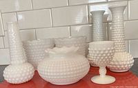 All seven Imperial hobnail milk glass pieces displayed together