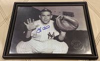 Front view of framed signed Yogi Berra photo showing full image, autograph and embossed stamp