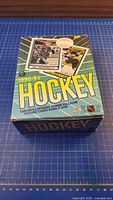 Top view of closed 1990-91 O-Pee-Chee Hockey box showing graphics and sample cards