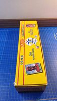 Closed yellow 1990 Score collector set box side view