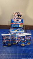 Front view of four sealed 1991 Pro Set Series 2 NFL card packs in blue foil packaging