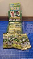 Four sealed 1992 O-Pee-Chee Premier NHL card packs in front of original display box