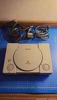 Top view of Sony PlayStation 1 console with cords
