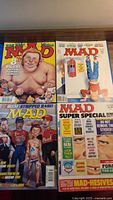 All four MAD magazines laid out showing covers