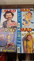Group shot of four MAD magazines laid out