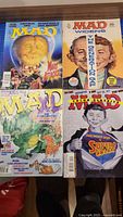 Four Mad magazines laid out showing all covers