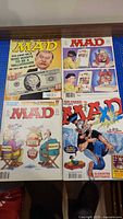 Four MAD magazines laid out showing all covers