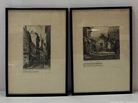 Both framed etchings side by side