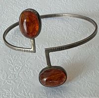 Full view of curved cuff showing both amber stones