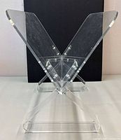 front angled view of clear acrylic X-form magazine rack