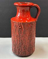 Full front view of red fat lava jug vase