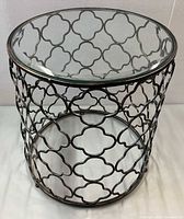 Full view showing glass top and metal base quatrefoil design