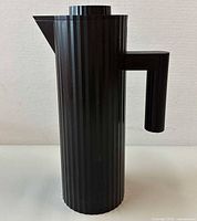 Front view of black ribbed vacuum jug with handle and spout