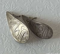 Front view showing Haida engraved design on both earrings