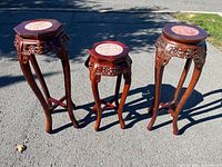 Three carved wood plant stands side by side to show relative sizes and condition