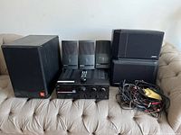 Full lot: JBL subwoofer, three Bose vertical speakers, JVC receiver, two Bose rectangular speakers, wire bundle
