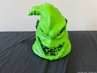 Front view of green Oogie Boogie light-up popcorn bucket