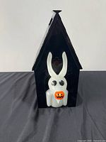 Front view showing Zero figure on house-shaped bucket