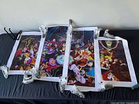 All four Disney villain canvas panels laid out on surface showing artwork and borders