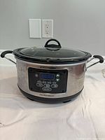 Front view of Hamilton Beach stainless slow cooker showing digital control panel and lid