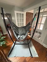 Assembled hammock stand with grey hammock seat suspended