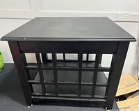 Front view of black painted wood side table