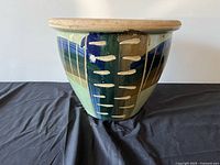 Exterior of painted ceramic planter showing glaze pattern and shape