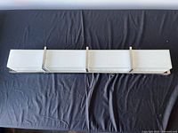 Front view of LED chrome vanity light showing four-section frosted diffuser and chrome brackets