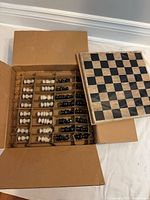 Chess set in open box showing board and packaged pieces
