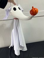 Front view of hanging Zero decoration showing head, pumpkin nose, draped body and ears