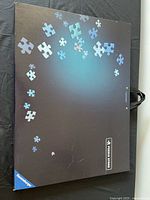 Exterior of Ravensburger Puzzle Store case showing graphics and carry handle